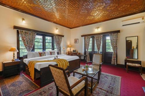 a bedroom with a bed and a living room at SaffronStays Awakening -Family Suite in Srinagar