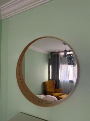 a mirror on a wall with a chair in a room at Imperial Rabat - MAKE IT YOURS in Rabat
