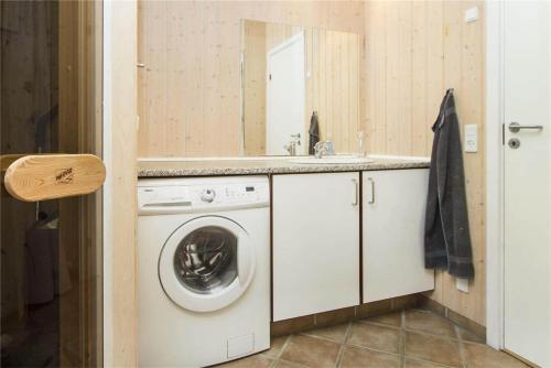 a bathroom with a washing machine and a sink at BL481-Pandrup-Rodhusparken-10 in Pandrup
