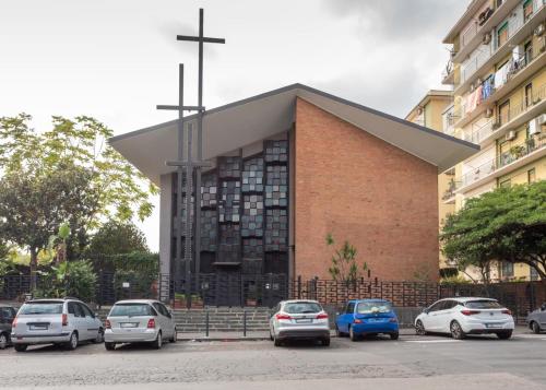a church with cars parked in front of it at Rocca Rooms in Catania