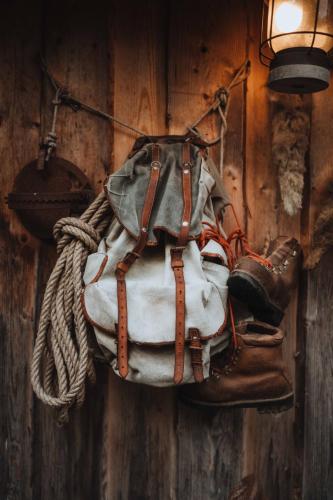 a backpack and boots hanging on a wall at Chalet trappeur in Le Biot