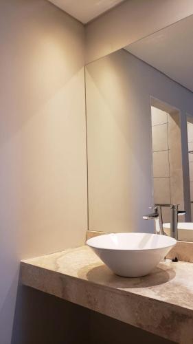 a white bowl sink on a counter in a bathroom at Hotel Finca Alvear in General Alvear