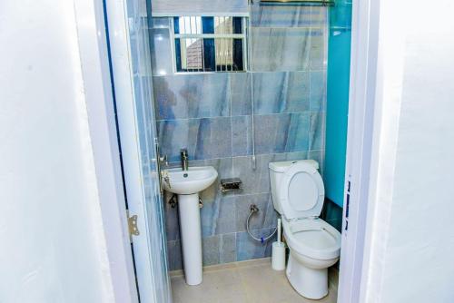 a bathroom with a toilet and a sink at Luxury BDR Wi-Fi Games in Abuja