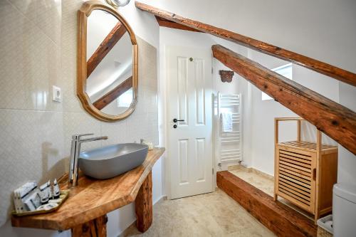 a bathroom with a sink and a mirror at Casa Baritiu M in Braşov