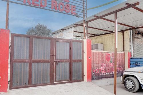 a garage with two doors in front of a building at Hotel O RED ROSE HOTEL in Alwar