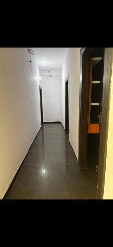 an empty hallway of a building with two doors at Hotel IC TOWER in Noida