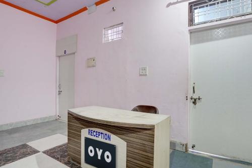 a desk with a sign on it in a room at Hotel O RED ROSE HOTEL in Alwar
