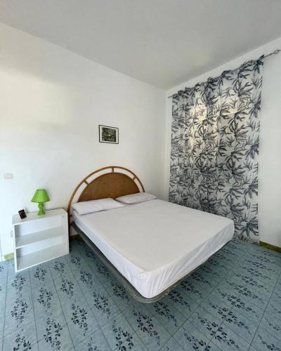a bedroom with a large bed with a white bedspread at Dimora del Verde in Forio d'Ischia