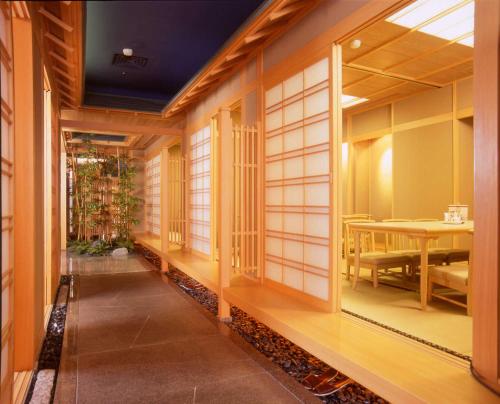 a hallway with a table and chairs in a building at Brother Hotel in Taipei