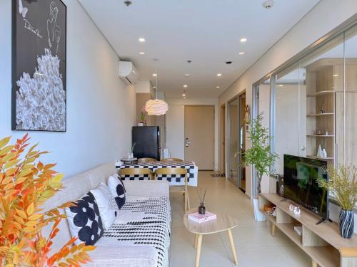 a living room with a couch and a tv at Gạo's Homestay - The Song in Vung Tau