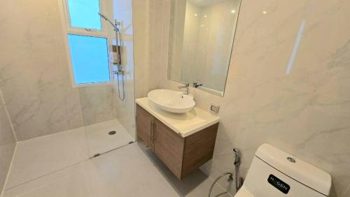 a white bathroom with a sink and a mirror at My Resort Huahin by Ying in Hua Hin