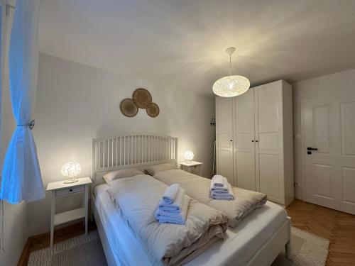 a bedroom with a bed with two towels on it at Mileticova street, keyless, AC in Nivy
