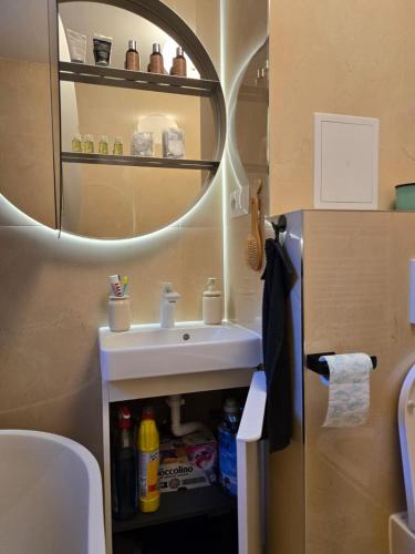 a bathroom with a sink and a mirror at Mileticova street, keyless, AC in Nivy