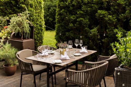 a wooden table with wine glasses on a patio at Austria Trend Hotel Congress Innsbruck in Innsbruck