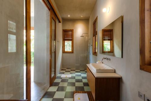 a bathroom with a sink and a shower at ZIN Berawa Villas & Bungalows in Canggu