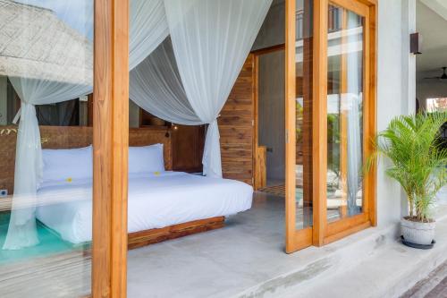 a bedroom in a villa with a bed at ZIN Berawa Villas & Bungalows in Canggu