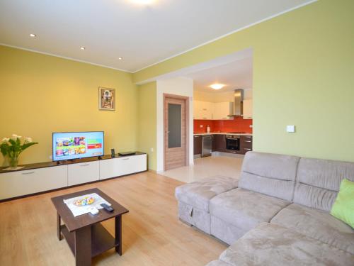 a living room with a couch and a tv at Apartment Marijo by Interhome in Matulji