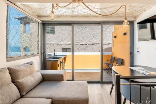 a living room with a couch and a table at Yellow Wave in Paul do Mar
