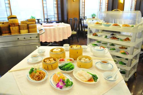 a table with various dishes of food on it at Brother Hotel in Taipei
