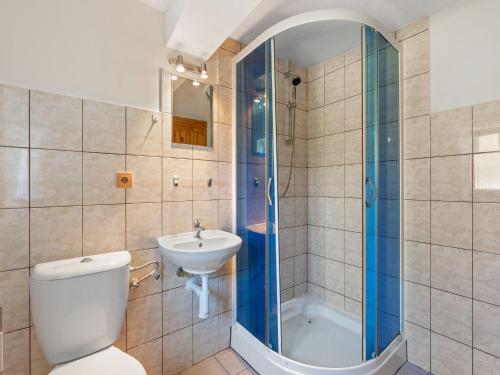 a bathroom with a toilet and a sink and a shower at Holiday Home Lenora I by Interhome in Lenora