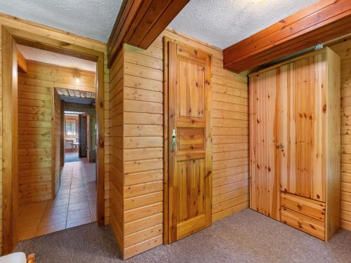 a log home hallway with wooden walls and doors at Holiday Home Lenora I by Interhome in Lenora