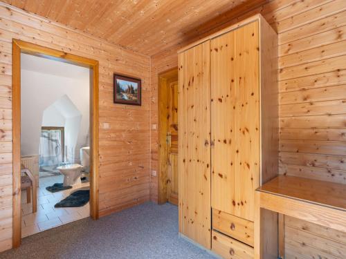a log cabin bathroom with a toilet and a sink at Holiday Home Lenora I by Interhome in Lenora