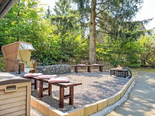 a group of picnic tables sitting in a park at Holiday Home Sorgenfrei by Interhome in Frankenau