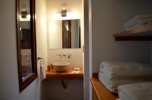 a bathroom with a sink and a mirror at La Araucaria in Villa La Angostura