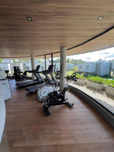 a gym with cardio equipment on the roof of a building at Bangalô moderno e super bem equipado in Passo de Camarajibe