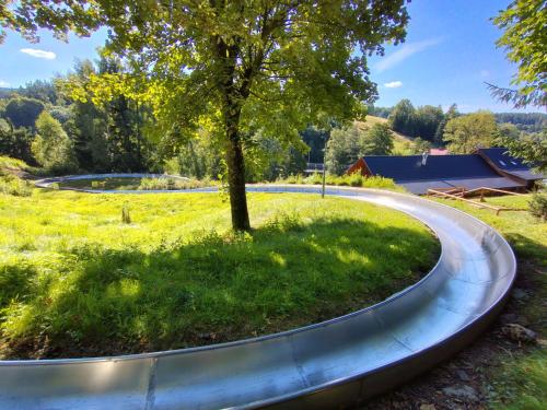 a winding road around a tree in a field at Chalet Sedmidomí by Interhome in Horní Maxov