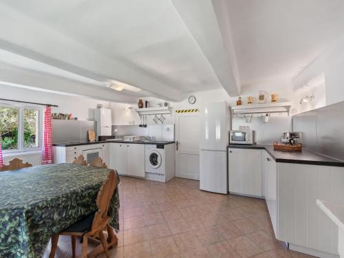 a kitchen with white cabinets and a table in a room at Holiday Home Lenora II by Interhome in Lenora