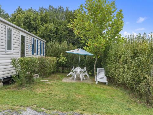 a patio with an umbrella and a table and chairs at Holiday Home Prima by Interhome in Koloděje nad Lužnicí