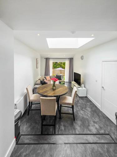 a living room with a table and chairs and a couch at Modern Flat near Wembley stadium in The Hyde