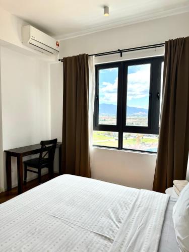 a bedroom with a bed and a window with a desk at Ipoh Peaceful Onsen studio Lost World Tambun in Tambun