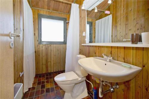 a bathroom with a sink and a toilet and a mirror at BL363-Saltum-Nyborgvej-4 in Saltum