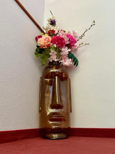 a vase with flowers in it on a wall at AH Carinthia Mallnitz - Carinthia Appartements in Mallnitz
