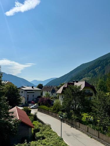 a city street with houses and mountains in the background at AH Carinthia Mallnitz - Carinthia Appartements in Mallnitz