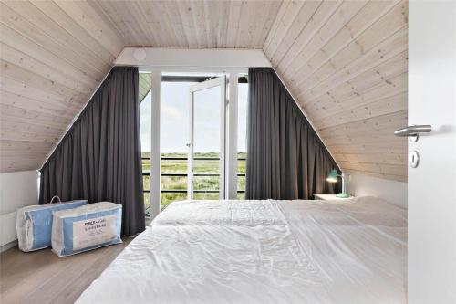a bedroom with a large bed and a large window at BL1193-Pandrup-Narhvalen-14 in Pandrup