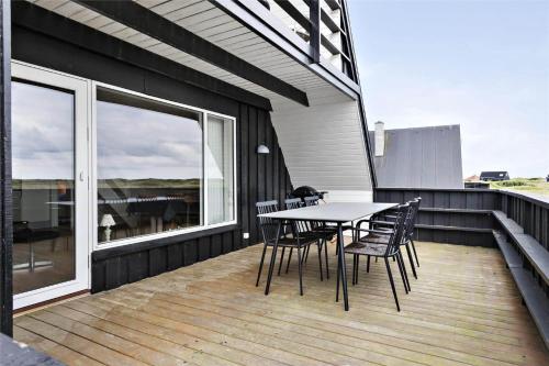 a patio with a table and chairs on a balcony at BL1193-Pandrup-Narhvalen-14 in Pandrup