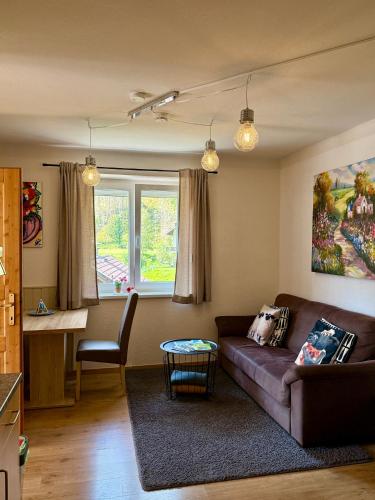 a living room with a couch and a table at AH Carinthia Mallnitz - Carinthia Appartements in Mallnitz