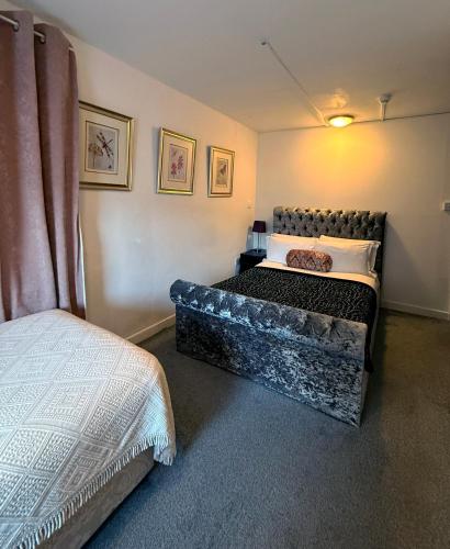 a bedroom with a bed in a room at Sids restaurant and bar with rooms in Cardiff
