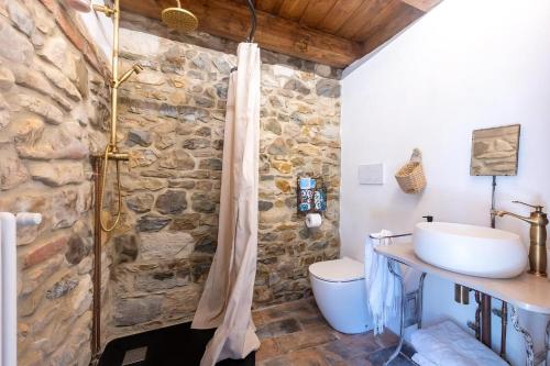 a bathroom with a sink and a stone wall at Sul lago in Salsomaggiore Terme