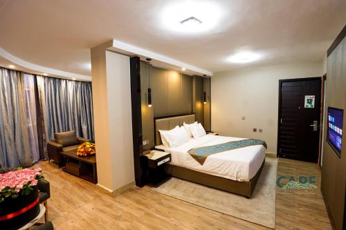 a bedroom with a bed and a living room at Cape Hotel in Addis Ababa