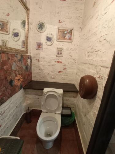 a small bathroom with a toilet in a room at Veranda Grill in Sumy