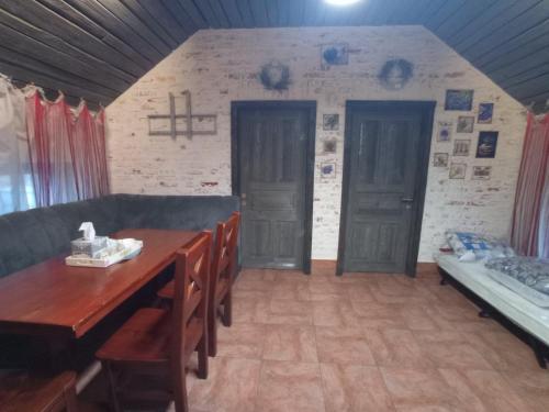 a dining room with a table and chairs and a bed at Veranda Grill in Sumy