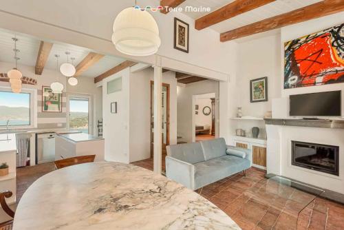 a living room with a table and a fireplace at Luxury Penthouse, Terre Marine in Lerici
