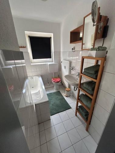a small bathroom with a sink and a toilet at Apartment Schmachtendorf in Oberhausen
