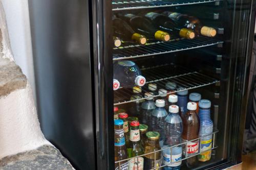 an open refrigerator filled with lots of beer bottles at BnB Feuille de Vigne in Saint-Léonard