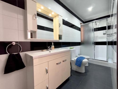 a bathroom with a sink and a toilet and a shower at JP Castle Resort in Chios