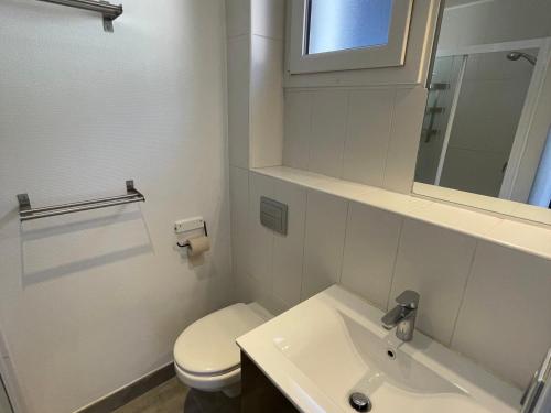 a white bathroom with a toilet and a sink at Charmant T2 pour 4 pers avec Sauna, WiFi et Parking privé - FR-1-263-88 in Valloire